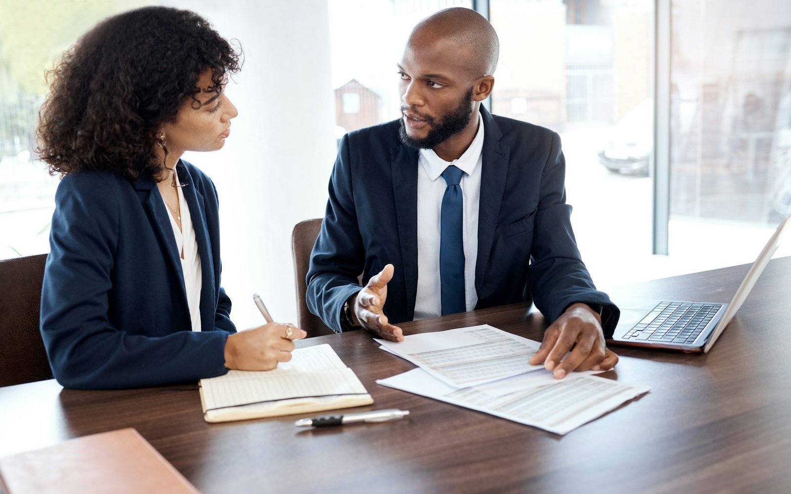 Business, planning and black people meeting with documents, report and contract review in office. F